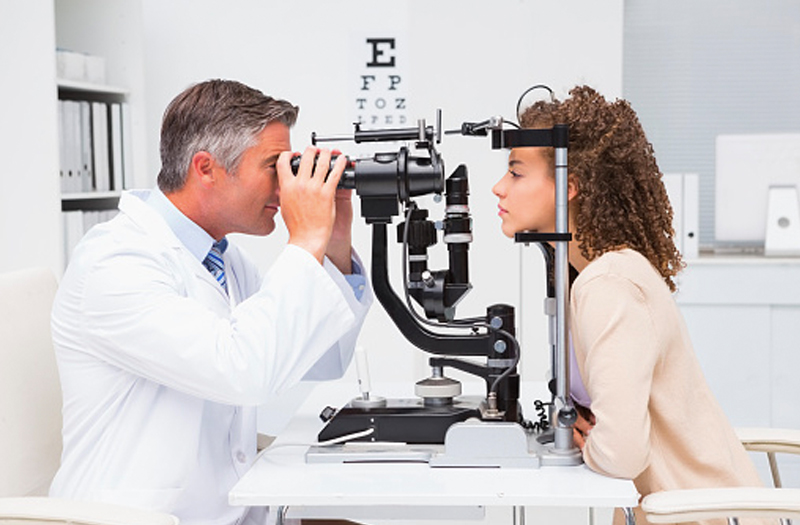 optometrist examining patient's eyes, western MA optometrist, eye doctor western MA, eye doctor Springfield MA